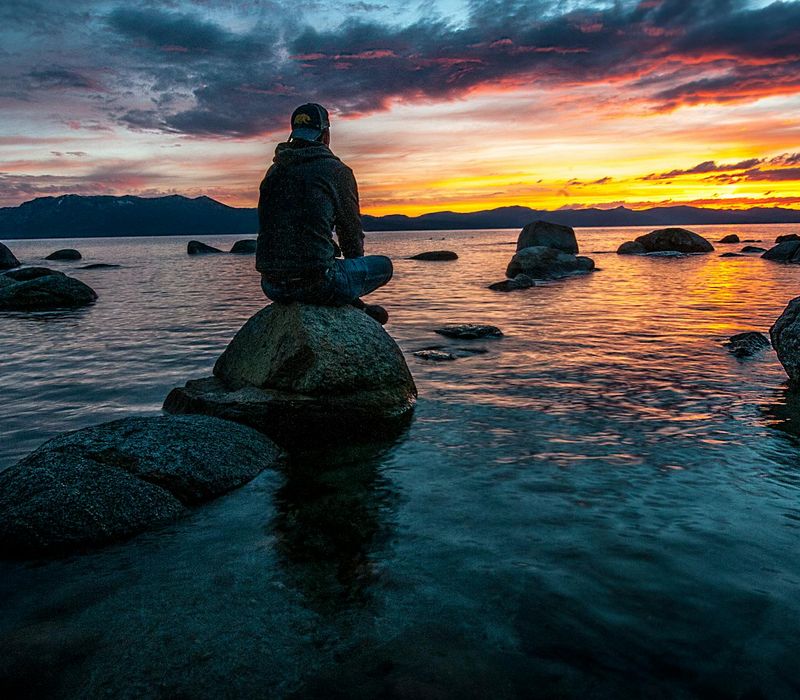 Silhouette of a person meditating during a beautiful sunset.